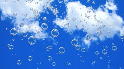 Bubbles floating against a blue sky with clouds.