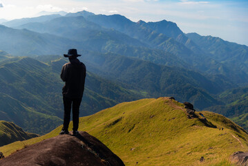 Hiker asian happy feeling freedom good and strong weight victorious facing on the natural mountain. Travel Concept