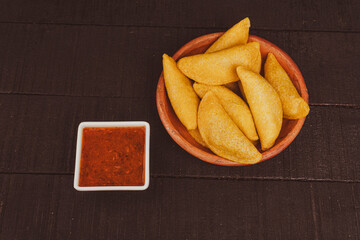 Colombian empanada with spicy sauce