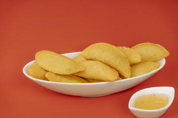 Colombian empanada with spicy sauce (