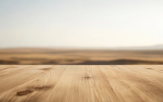 Ground level angle view close up, surface of light maplewood table, with a minimalist surrounding of soft blurred desert horizon, soft beige lighting, and clean neutral tones, showcasing copy space