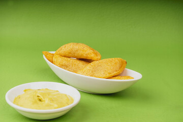 Colombian empanada with spicy sauce (