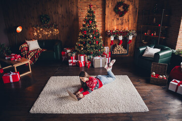 Photo of nnice pretty woman wear new red clothes lying on carpet enjoying christmas festive time weekend decorated room indoors