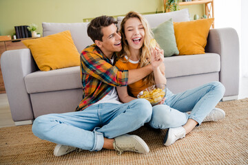 Full body photo of nice young couple sit floor hugging enjoy modern bright spring cozy interior flat indoors