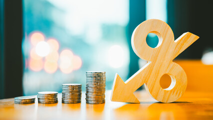 Percentage model, coin stack and down arrow, concepts for success, methods, systems of raising or lowering Fed interest rates to correct inflation concepts. © sommart