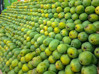 background with piles of mangoes on display and for sale