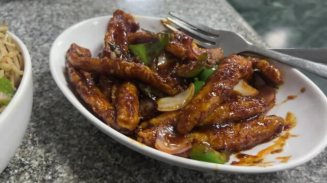 Cinematic shot of crispy chilli, baby corn fried with capsicum and onion
