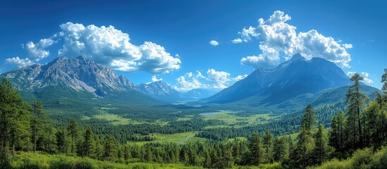 Breathtaking mountain landscape under a clear blue sky with vibrant clouds and lush greenery in the foreground.