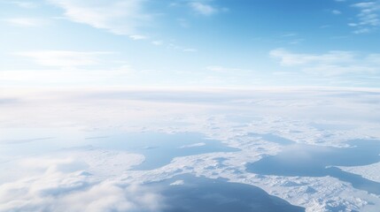 Aerial view of tranquil ice formations and serene ocean under a bright sky with soft clouds showcasing nature's untouched beauty