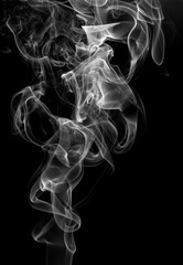 Cigarette smoke movement abstract on black background. white smoke on dark
