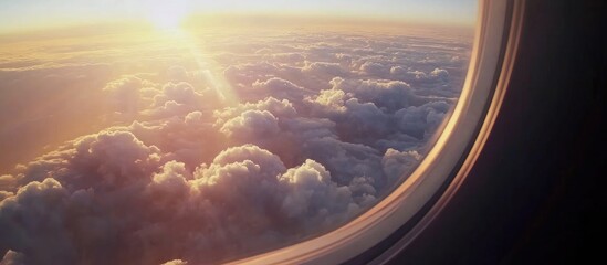 Stunning aerial view from an airplane window showcasing vibrant clouds and sunlight during daytime flight