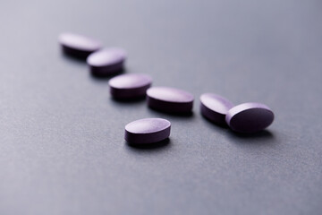 Lutein tablets. Dietary supplement on paper background. Soft focus. Close up. Copy space