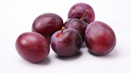 Obraz premium Vibrant plums arranged artistically on a clean white background showcasing their rich color and natural beauty for food photography.