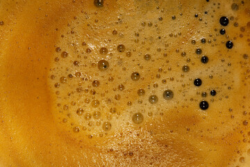 Frothy black americano coffee background backdrop made in a  coffee machine. Hot beverage filter...