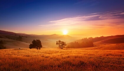 Golden Hour Serenity: A breathtaking sunset paints the sky with vibrant hues, casting a golden glow over a rolling landscape of hills and fields. The image evokes a sense of tranquility and peace.