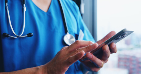 Person, hands and nurse with phone for medical research, communication or telehealth at hospital in city. Closeup, japan or doctor with mobile smartphone for online browsing or health app at clinic