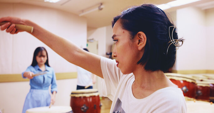 Japanese drums, teacher or people in practice for music on instrument for stage creativity, advice or song. Taiko, women or coaching drummers in band to play in rehearsal for culture, rhythm or beat