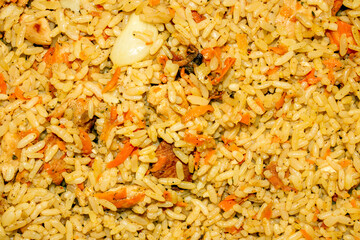 Uzbek pilaf.Pilaf with chicken and spices.Pilaf with meat background.The texture of pilaf.Rice pilaf with chicken.