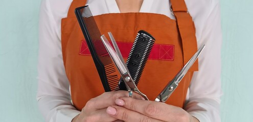 Woman hairdresser holding combs and scissors for hair cutting