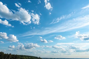 Obraz premium A breathtaking view of a vibrant blue sky adorned with fluffy cumulus clouds and wispy cirrus formations, creating a serene and picturesque landscape