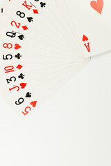 Top view of playing cards on white background. Board game, poker. Copy space, flat lay.
