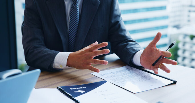 Businessman, hands and documents with explanation for proposal, contract or project budget at office. Japan, closeup or man with speech or paperwork for corporate planning, finance or business deal
