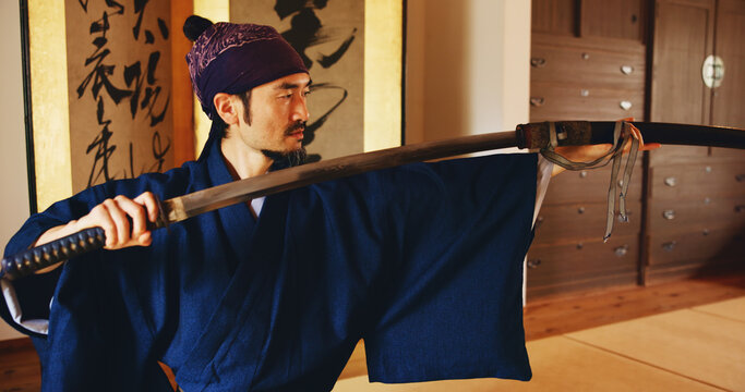Dojo, sheath and sword with Samurai man in Japan for combat, martial arts or training, Discipline, Kenjutsu and weapon with Japanese person in kendogi for culture, exercise or practice routine