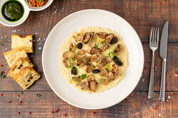 Porcini mushroom risotto in a white porcelain plate, risotto ai funghi porcini