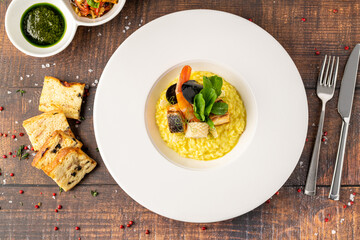 Seafood risotto, risotto alla pescatora, served on a white porcelain plate