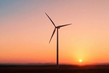 Obraz premium Wind turbine generating clean energy at sunset in rural landscape