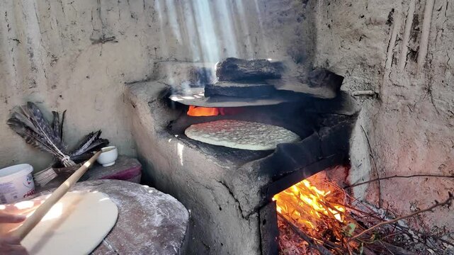 preparing bread in a traditional Dagestan village bakery. Bread is a flatbread baked in a Koryuk oven, common in the cuisine of the North Caucasus.