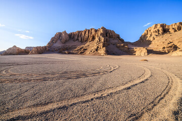 Desert sand ground and Yardang landform mountain natural landscape in Xinjiang, China. Road trip in no man's land. Outdoor natural background.