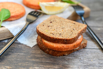  Fishburger.Homemade ketogenic  Salmon Burger with Tartar Sauce and  whole grain ketgenic bread. Healty  low carb high protein food
