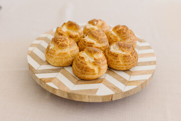 choux cream or cream puff or French profiteroles with fresh cream set on cafe table