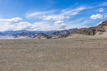 Desert sand ground and mountain natural landscape under the blue sky. Outdoor natural background.