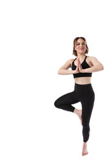 Fototapeta premium Beautiful young 20s or 30s Caucasian female woman doing yoga tree pose on white background for ad or copy space