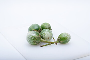 Fresh round green mini eggplant healthy vegetable photographed with white base and background