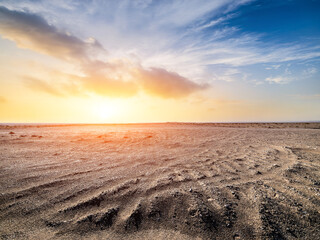 Desert sand ground and sky clouds at sunset. Outdoor natural background. © ABCDstock
