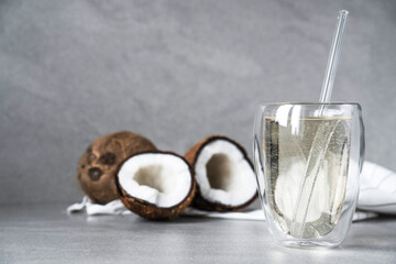 coconut water in a transparent glass with a glass tube, electrolytes from natural coconut