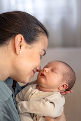 Mother kissing baby daughter. Newborn baby.