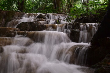Obraz premium Travel to waterfalls during the rainy season, The tiers of the waterfall contrast beautifully with the sky