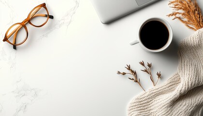 Obraz premium A cozy workspace setup featuring a coffee cup, glasses, and a soft sweater.