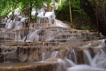 Obraz premium Travel to waterfalls during the rainy season, The tiers of the waterfall contrast beautifully with the sky, Nature itself is the best physician