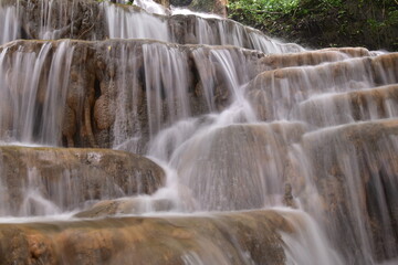 Fototapeta premium Travel to waterfalls during the rainy season, The tiers of the waterfall contrast beautifully with the sky, Nature itself is the best physician