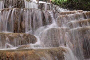 Obraz premium Travel to waterfalls during the rainy season, The tiers of the waterfall contrast beautifully with the sky, Nature itself is the best physician