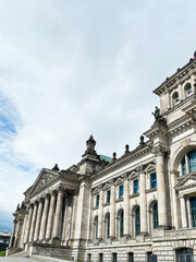 Historic architectural Reichstag building with neoclassical columns under blue sky