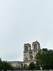 Iconic view of Notre-Dame Cathedral in Paris under cloudy skies