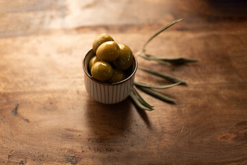 Fresh Green Olives in a Bowl on a Wooden Table
