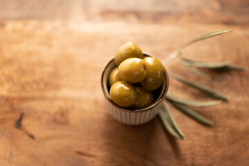 Fresh Green Olives in a Bowl on a Wooden Table
