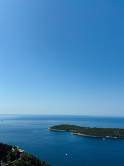 Serene seascape with clear blue sky and tranquil waters. Lokrum Island, Dubrovnik, Croatia.